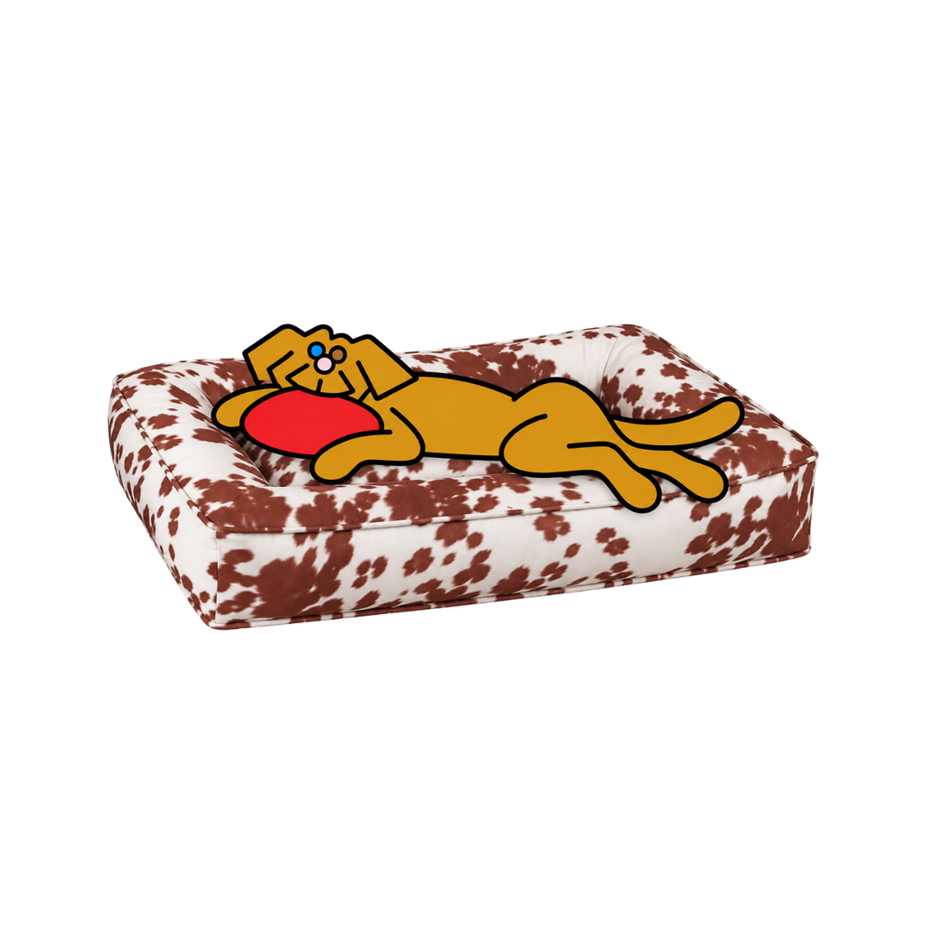 Bowsers Divine Futon dog bed in brown-and-white print with the illustrated Fetch dog reclining beside a red frisbee.