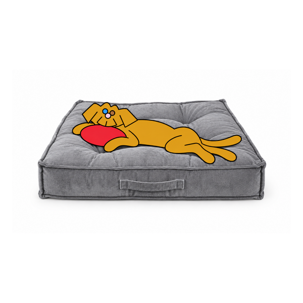 Bowsers Piazza dog bed in gray with the illustrated Fetch dog lounging sideways, his head resting on a red frisbee.